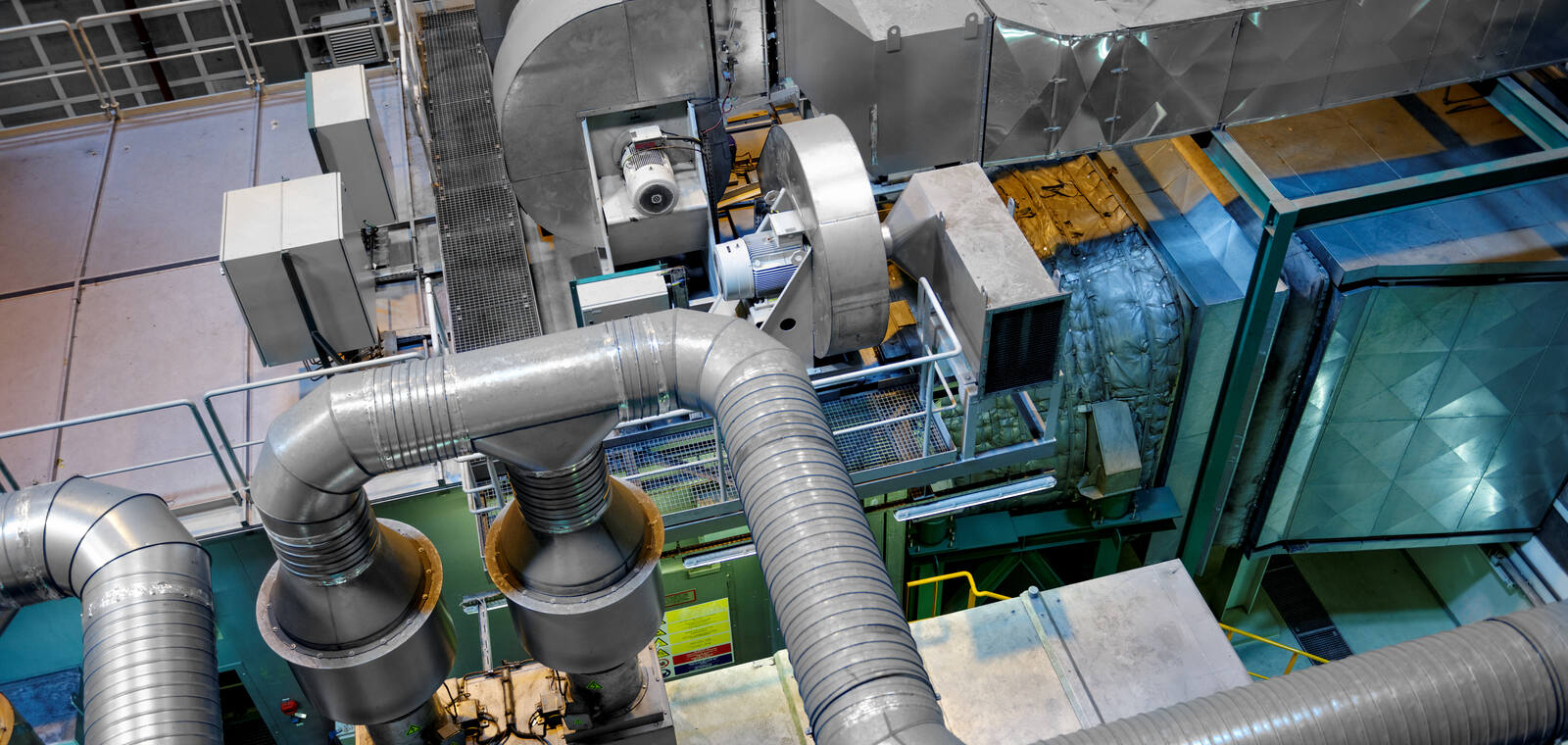 Large industrial plant interior with mechanical services and pipework