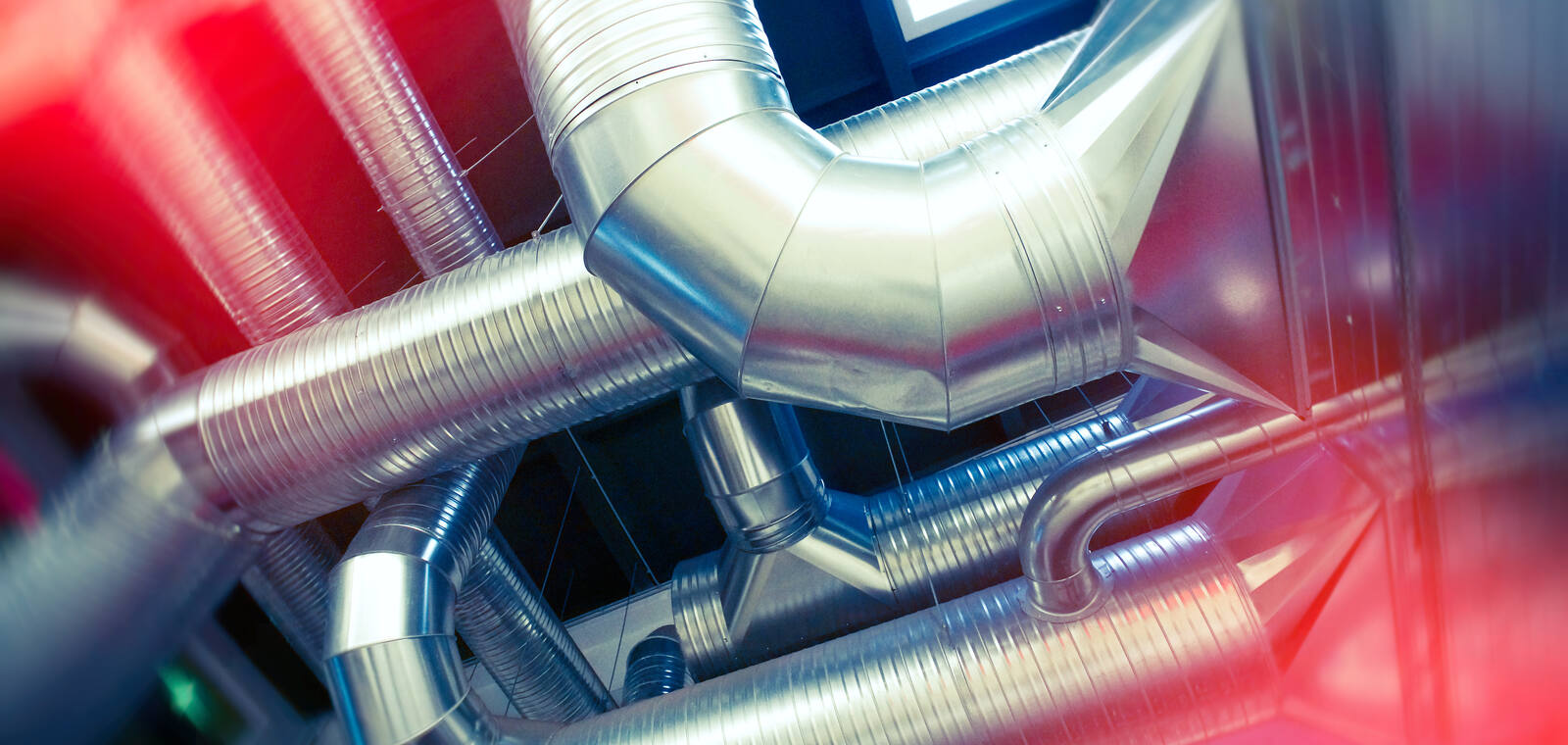 Large-diameter ventilation ductwork forming a VAV air-distribution system in a modern building