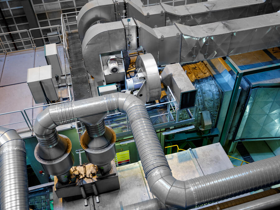 Industrial chilled-water plant interior with chillers and insulated process piping