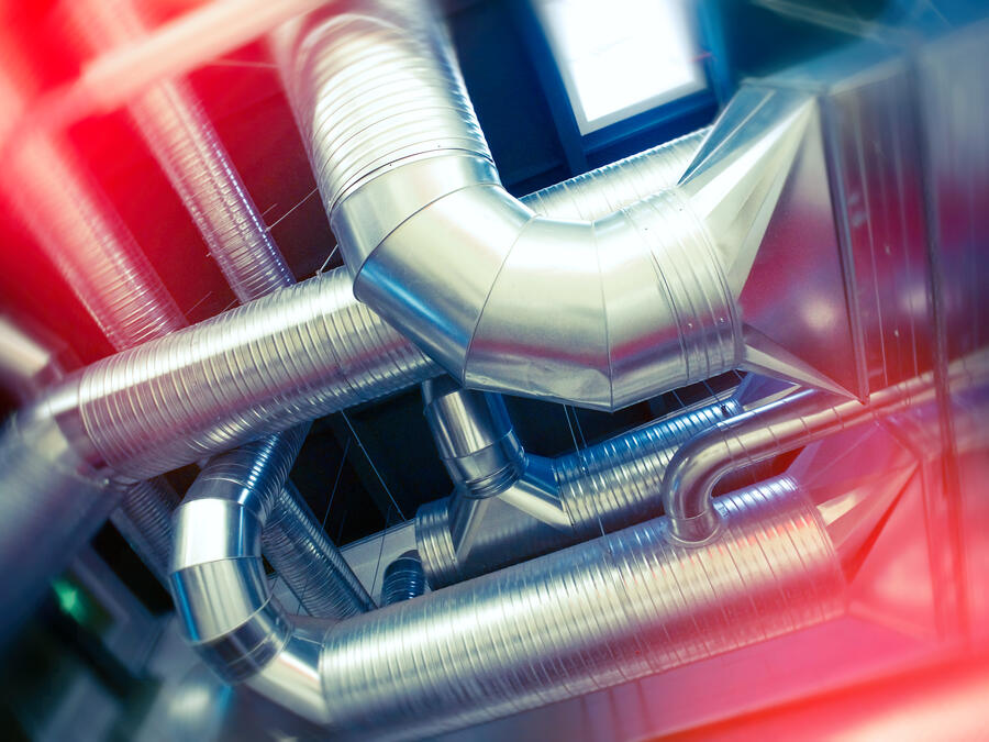 Large-diameter ventilation ductwork forming a VAV air-distribution system in a modern building