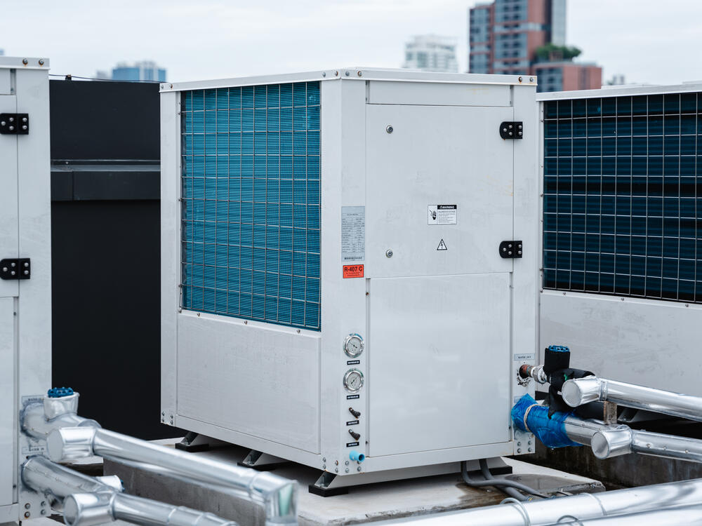 Rooftop HVAC condenser units installed in a clean industrial array